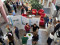 A group of people are gathered in a bright indoor atrium for a professional event or conference.